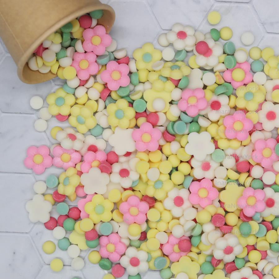 May include: A variety of pastel colored wax melt in the shape of small circles and flowers.