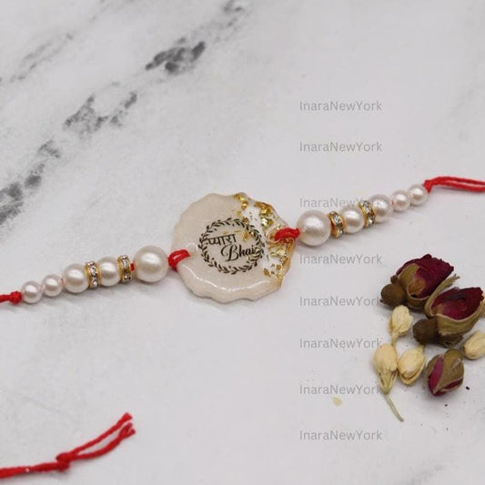 Resin Rakhi with Pearls & Gold Flakes — Elegant Raksha Bandhan Rakhi with Gift Packaging