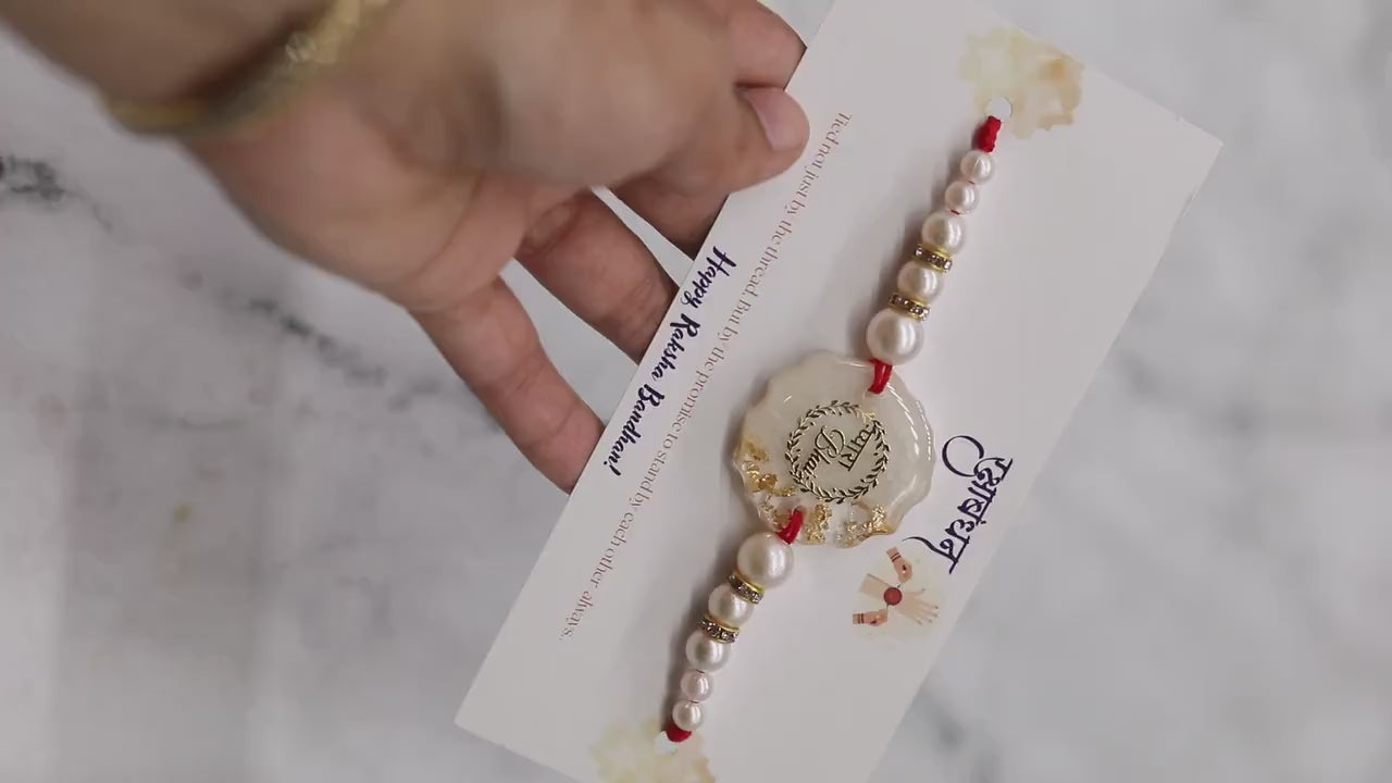 Resin Rakhi with Pearls & Gold Flakes — Elegant Raksha Bandhan Rakhi with Gift Packaging